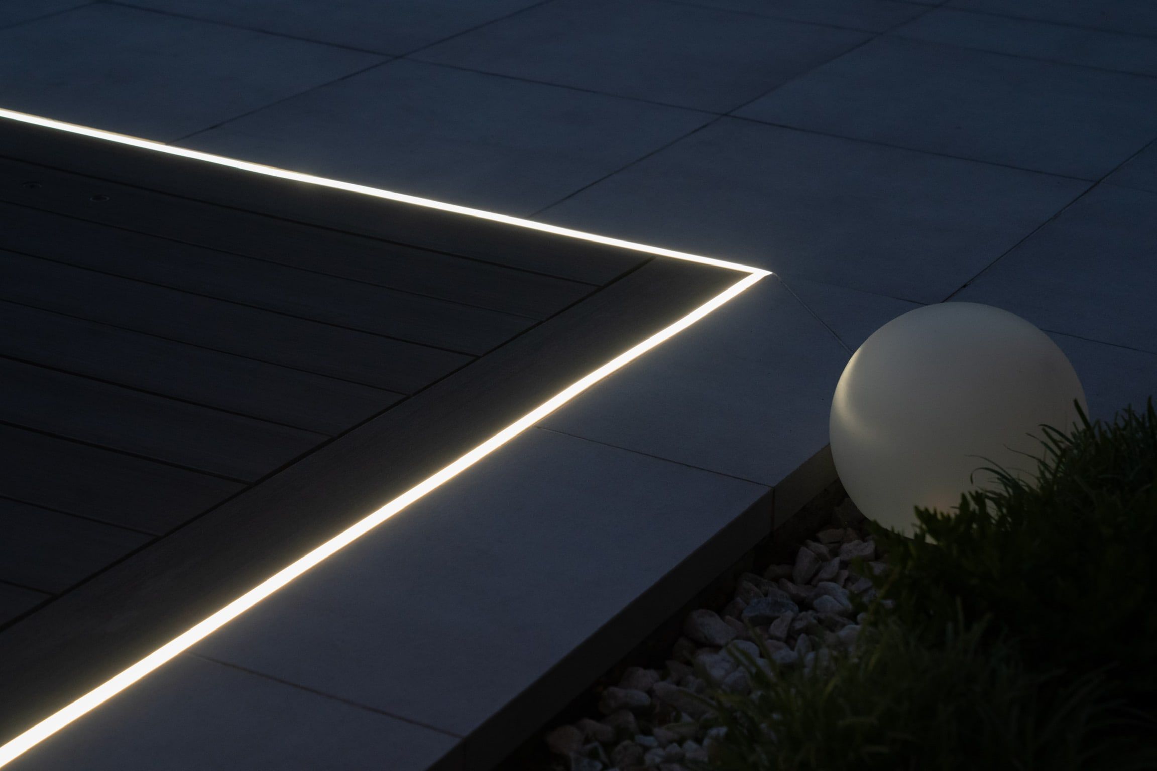 Close view of the deck-edge light line and a glowing garden sphere.