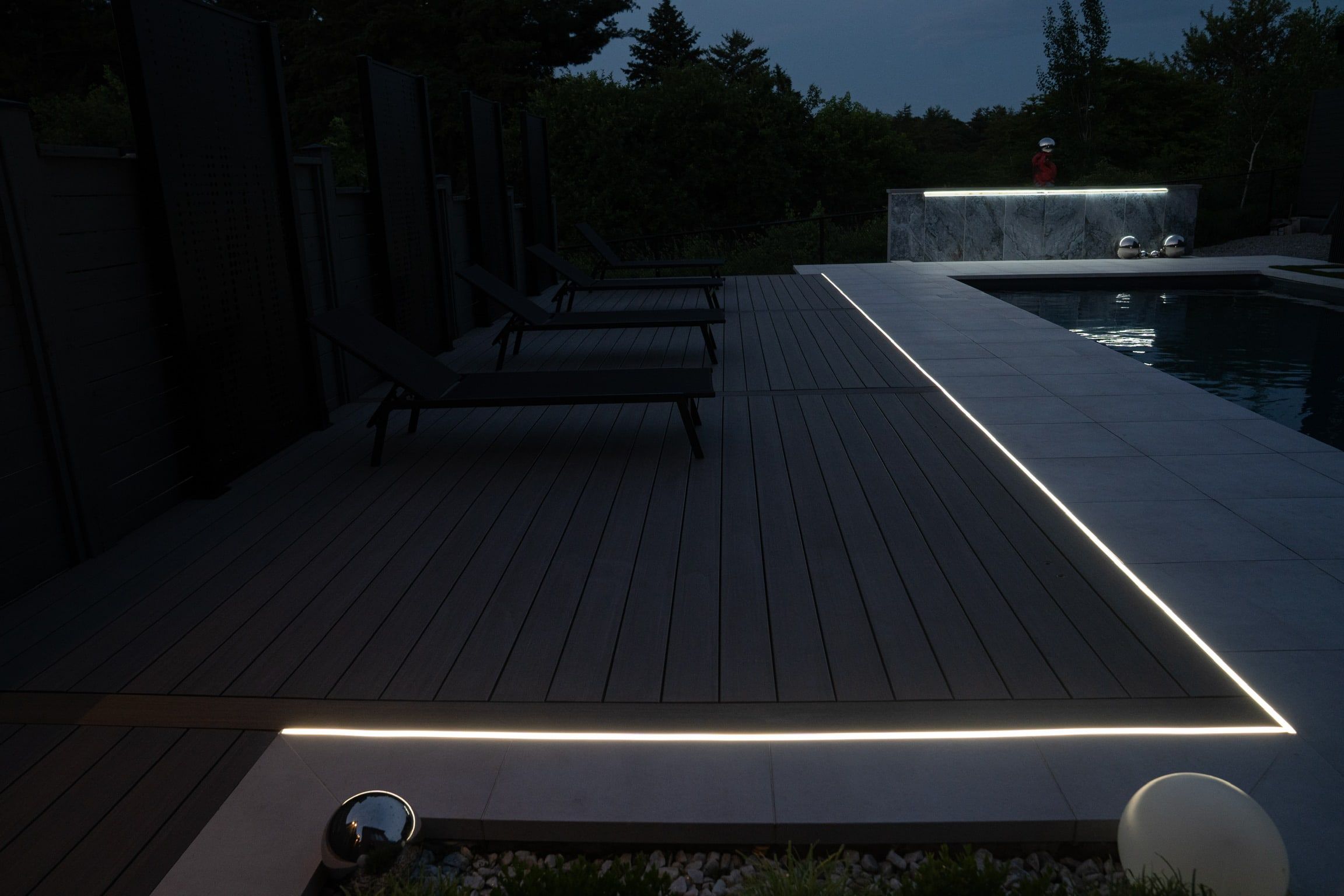 The deck-edge line running past the loungers toward the pool.