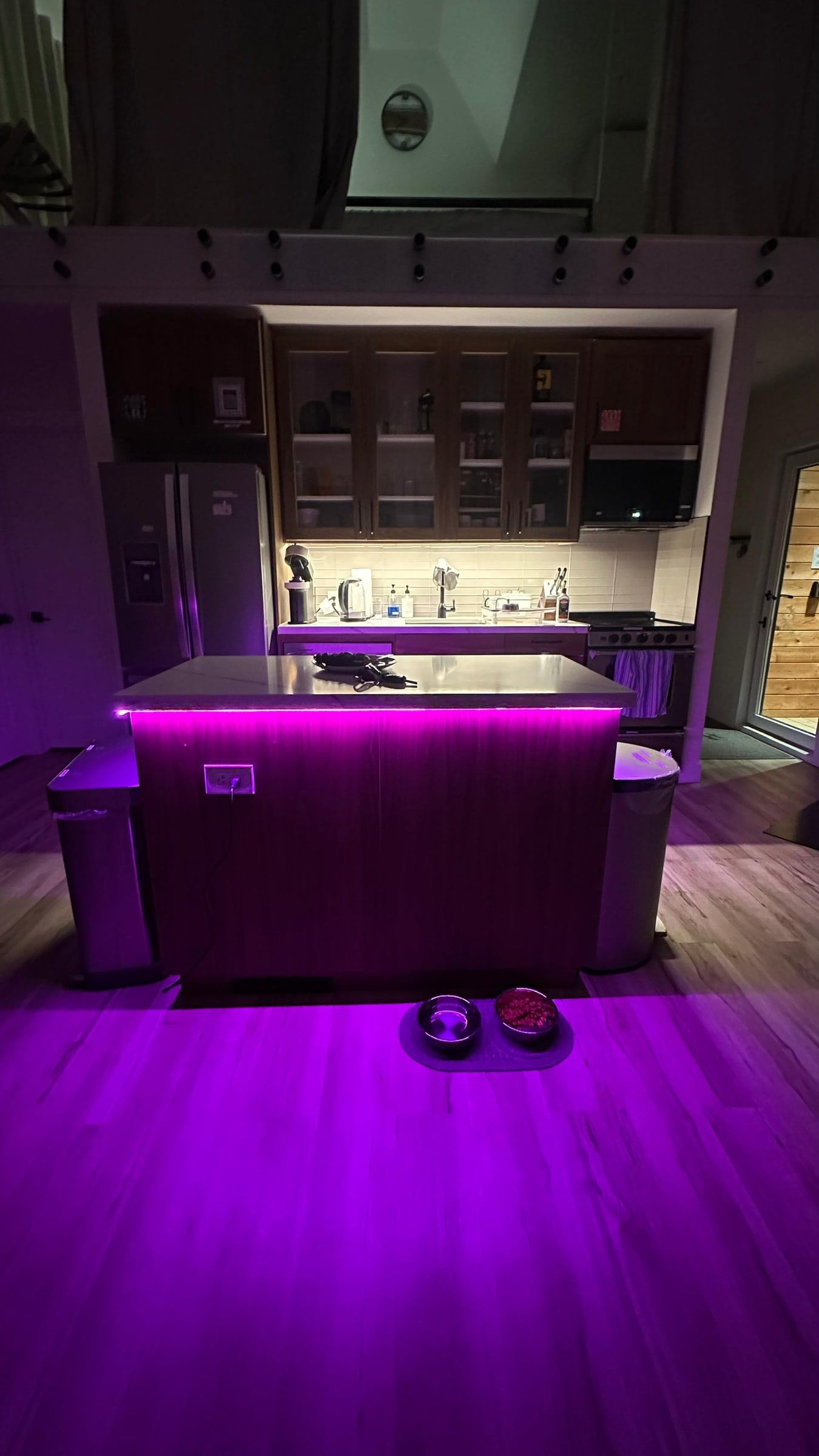A kitchen island with colour-changing light, shown in purple.